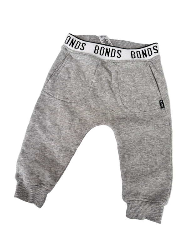 A pair of heather gray sweatpants with a white elastic waistband featuring the brand name 'BONDS' in black text, laid flat on a white background.