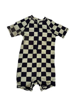Load image into Gallery viewer, A long-sleeve baby romper with a black and cream checkerboard pattern, laid flat on a white background.
