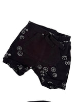 Load image into Gallery viewer, Black shorts with a white basketball print pattern, laid flat on a white surface.
