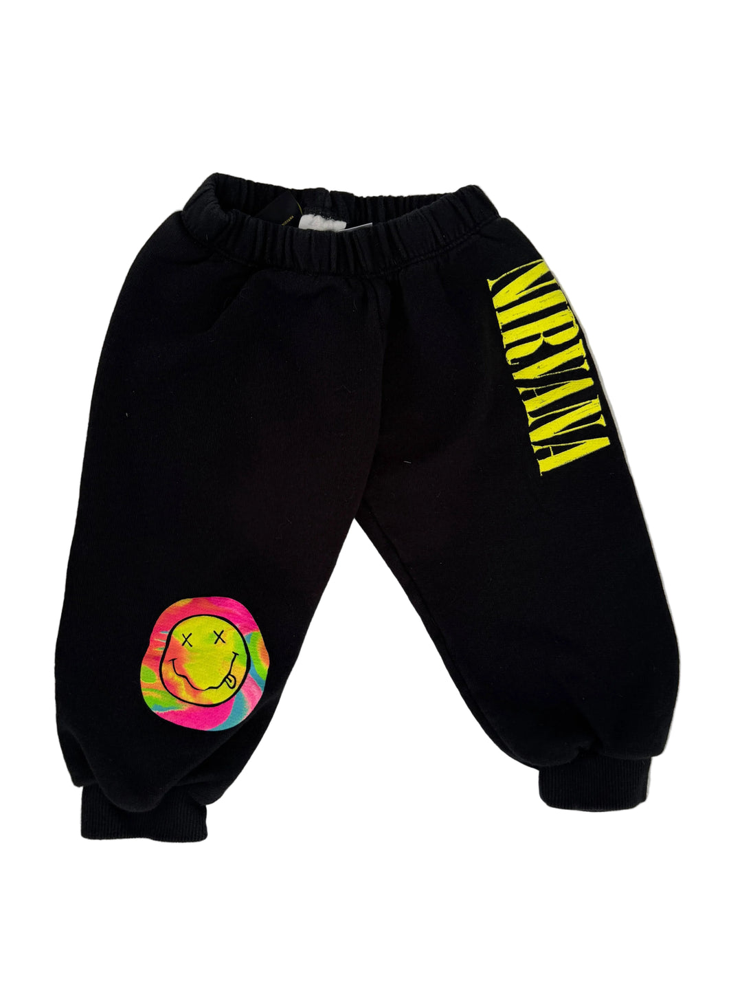 Black sweatpants featuring the yellow 'NIRVANA' logo on the upper left leg and a colorful peace sign graphic on the lower right leg, laid flat on a light gray surface.