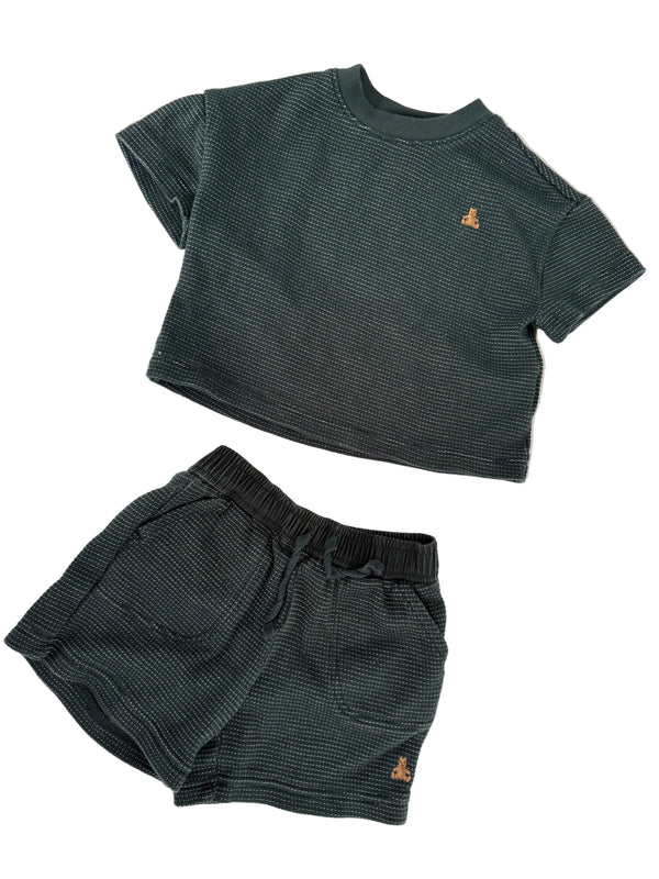 A two-piece children's outfit set consisting of a dark gray ribbed knit sleeveless top and matching shorts, laid flat on a white background.