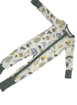 Load image into Gallery viewer, A baby's long-sleeve zip-up footed sleeper with an all-over woodland camping print on a white background, featuring dark green cuffs and a dark green zipper.
